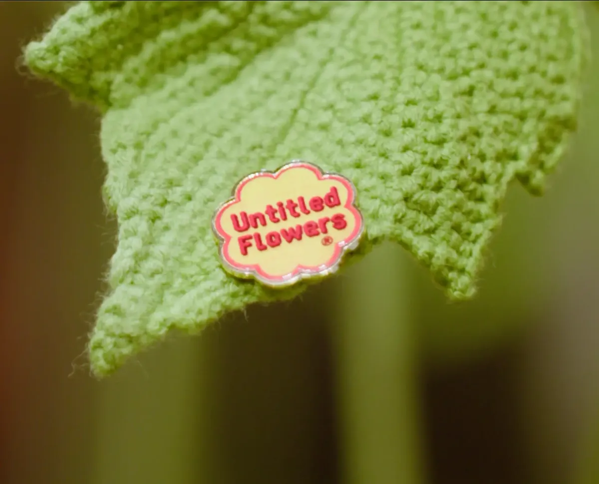 UF Pin close-up on a hand-crocheted green leaf