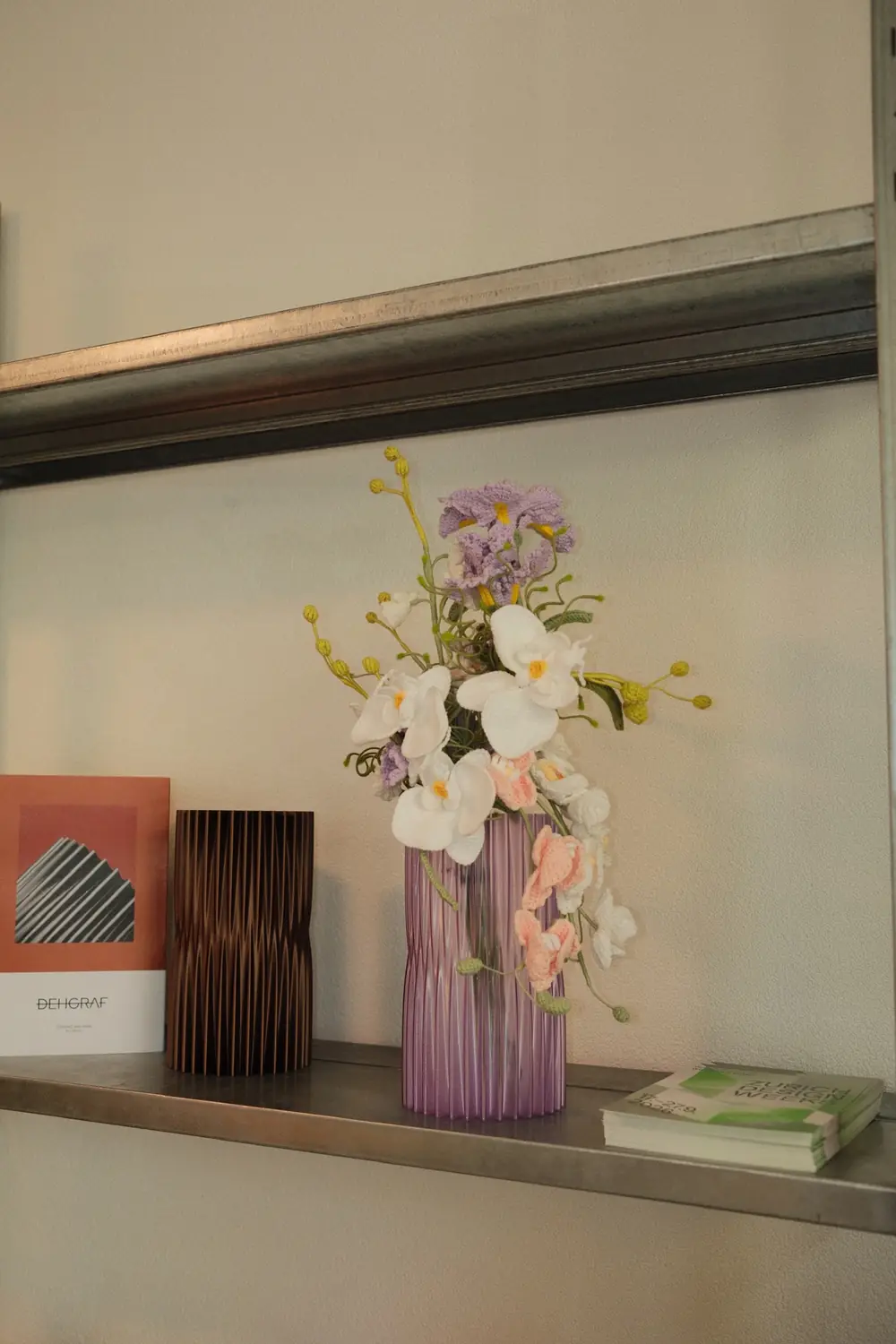 A hand-crocheted arrangement in a vase, in an interior